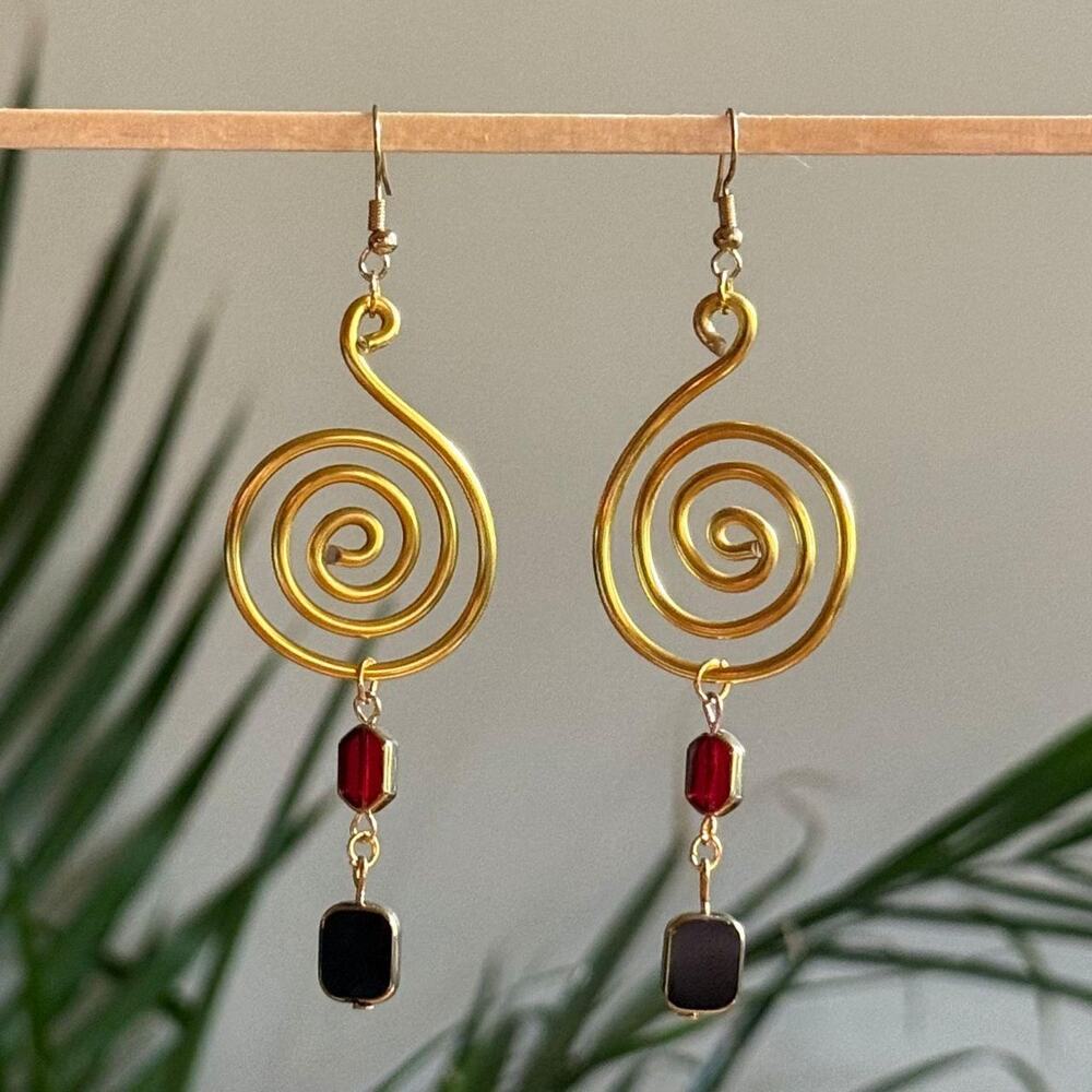 handmade gold wire spiral earrings with dangling red and black glass beads